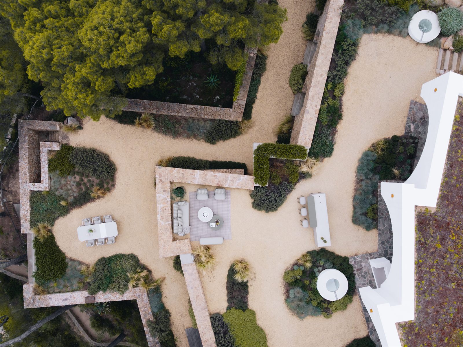 Aerial view of a complete LAVA outdoor kitchen and furniture landscape by the sea